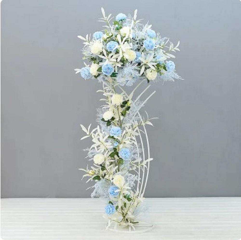 Decorative floral arrangement with blue and white flowers on a gray background