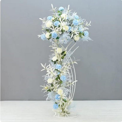 Decorative floral arrangement with blue and white flowers on a gray background